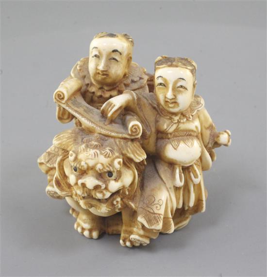 A Japanese ivory okimono of two boys with a Buddhist lion, Meiji period, height 5cm